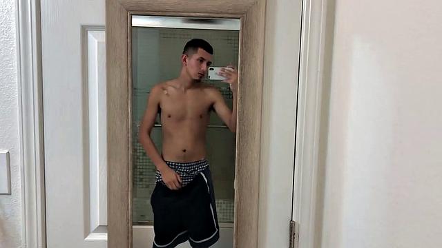 Slim and smooth Roman is in the bathroom, wearing only a pair of shorts. The young Latino gropes at his package until he's boned up. Then the shorts are pushed down to reveal his big uncut dick.