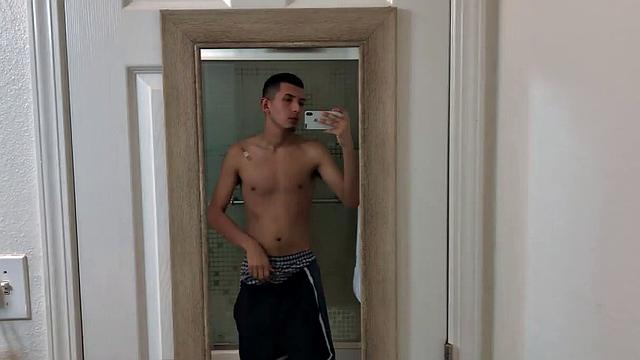 Slim and smooth Roman is in the bathroom, wearing only a pair of shorts. The young Latino gropes at his package until he's boned up. Then the shorts are pushed down to reveal his big uncut dick.