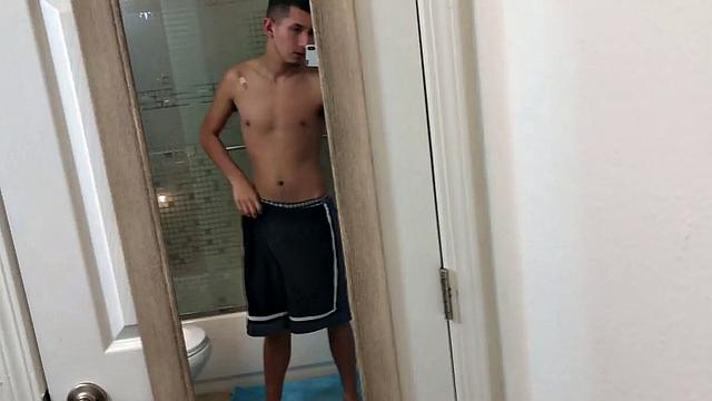 Slim and smooth Roman is in the bathroom, wearing only a pair of shorts. The young Latino gropes at his package until he's boned up. Then the shorts are pushed down to reveal his big uncut dick.