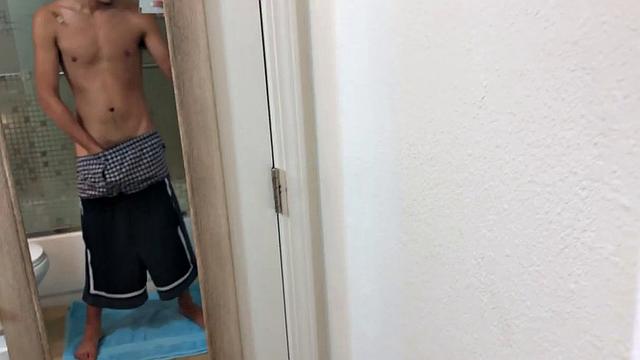 Slim and smooth Roman is in the bathroom, wearing only a pair of shorts. The young Latino gropes at his package until he's boned up. Then the shorts are pushed down to reveal his big uncut dick.