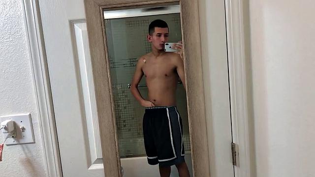 Slim and smooth Roman is in the bathroom, wearing only a pair of shorts. The young Latino gropes at his package until he's boned up. Then the shorts are pushed down to reveal his big uncut dick.