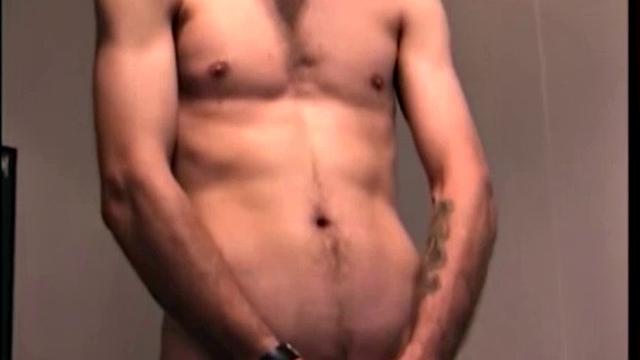 After the straight porno begins playing, Troy strips naked and begins stroking his cock, as the camera explores all the of his body.