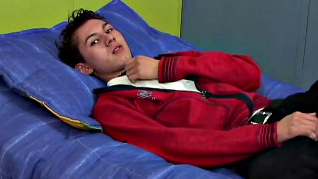 Latin twink Angel on bed strips down to underwear, grabs uncut cock, works up a stiff one, gets naked, jerks off