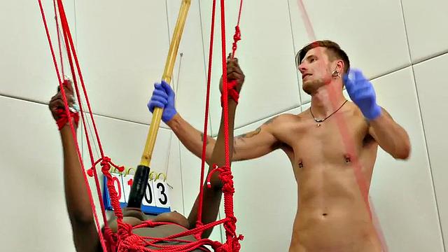 Bound ebony submissive hanging from ceiling