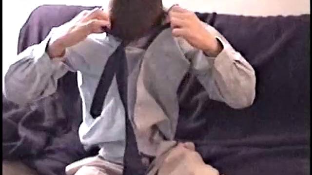 Darrell kicks back on the sofa, makes himself comfortable, rubs his package to work up a bulge, and then releases a big cock. At the same time, he pulls off his dress shirt and tie.
