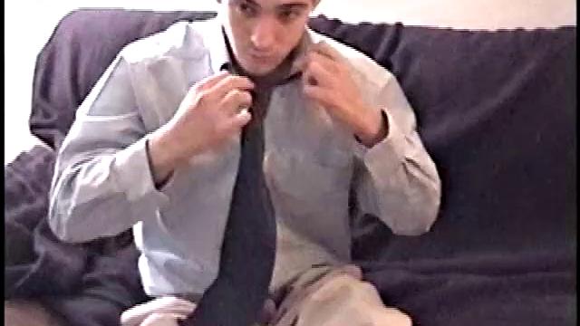 Darrell kicks back on the sofa, makes himself comfortable, rubs his package to work up a bulge, and then releases a big cock. At the same time, he pulls off his dress shirt and tie.