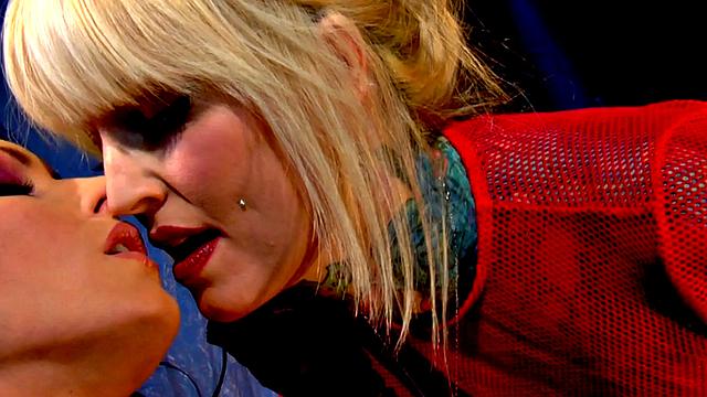 Watch these tattooed lesbians in lingerie finger and lick each other's pussies in fishnets and gloves