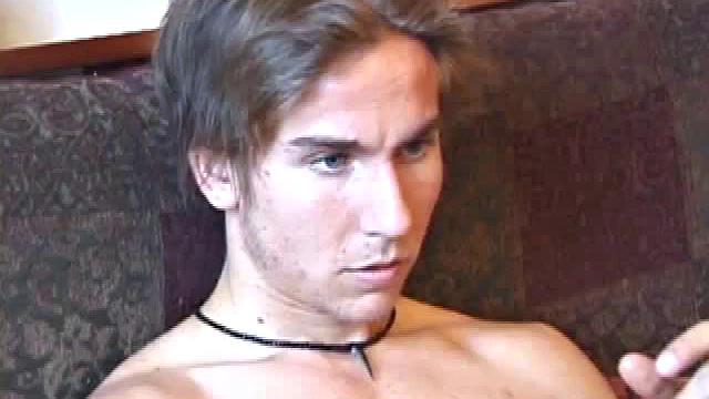 Naked and tuned into the porn video, scruffy Brock goes to work stroking his hard cock. After edging himself several times, the young man stands by the kitchen table and shoots a massive cum load on a cloth.