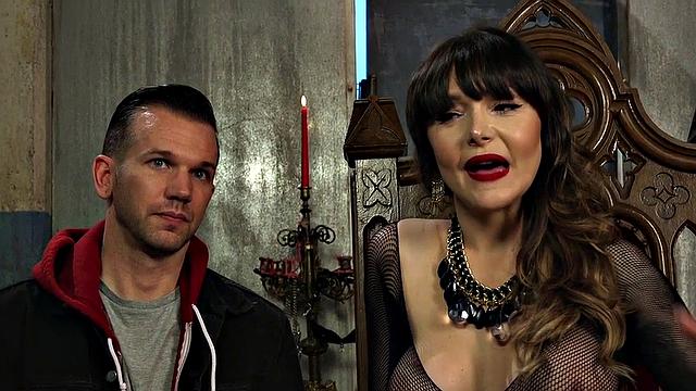 Subdued male pegged in dungeon by busty domina