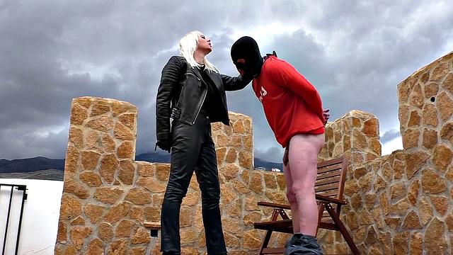 Blonde MILF in leather enjoys ballbusting & CBT in the great outdoors