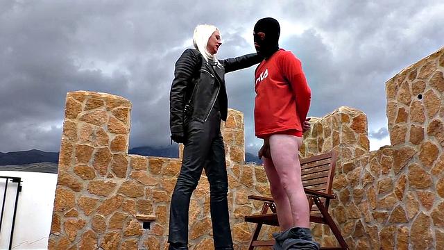 Blonde MILF in leather enjoys ballbusting & CBT in the great outdoors