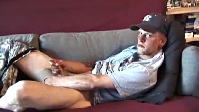Young amateur Brandon reclines on the sofa and pulls off his pants. While watching a video, he rubs his cock hard and fingers his ass.