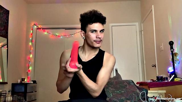 Latin boy Rio Rodriguez parks on a bed and strips to his underwear. After working up a boner, the young man gets naked and shoves a big fat dildo up his butt.