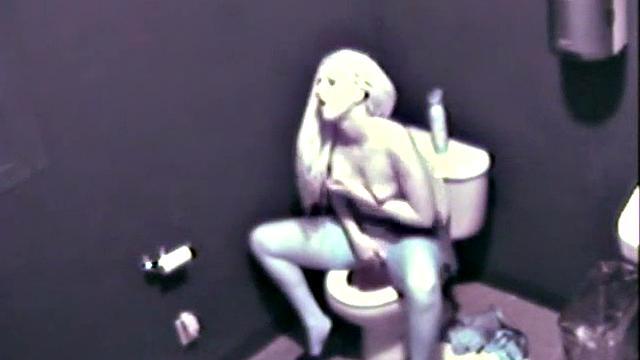 Sexy blonde fingering her pussy on the toilet