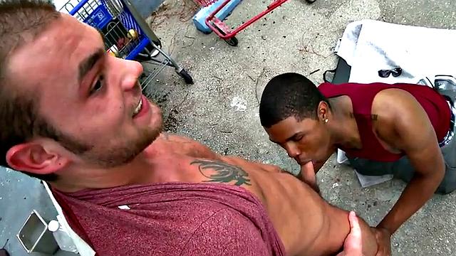 A wild interracial fuck with a tattooed bottom dude outdoors