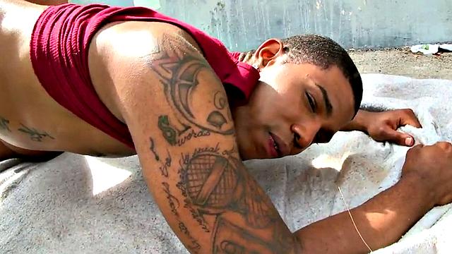 A wild interracial fuck with a tattooed bottom dude outdoors