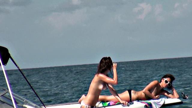 Brunette lesbians with glasses fish and suck on a boat in POV