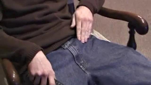 By the time the camera finds him, Dan is already going for his woody. A bit uncomfortable in the chair, he stands up and moves to the staircase, where we can see his hot cock getting harder and harder.