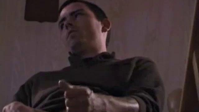 By the time the camera finds him, Dan is already going for his woody. A bit uncomfortable in the chair, he stands up and moves to the staircase, where we can see his hot cock getting harder and harder.