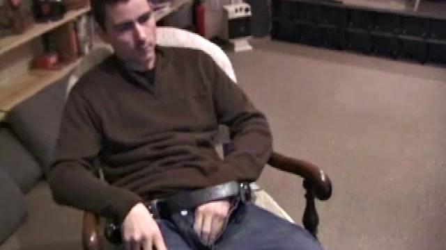 By the time the camera finds him, Dan is already going for his woody. A bit uncomfortable in the chair, he stands up and moves to the staircase, where we can see his hot cock getting harder and harder.