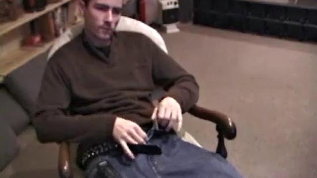 By the time the camera finds him, Dan is already going for his woody. A bit uncomfortable in the chair, he stands up and moves to the staircase, where we can see his hot cock getting harder and harder.