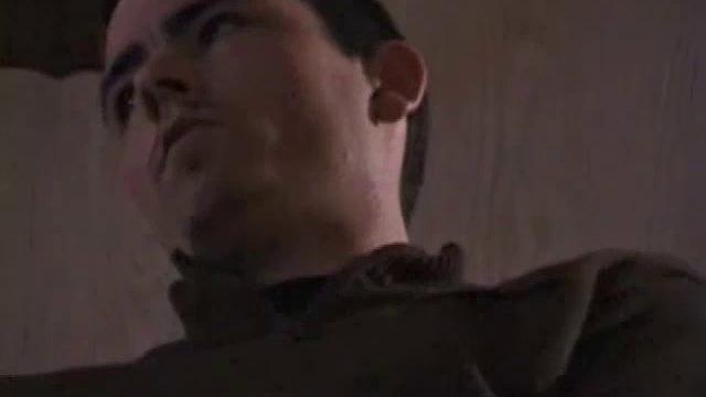 By the time the camera finds him, Dan is already going for his woody. A bit uncomfortable in the chair, he stands up and moves to the staircase, where we can see his hot cock getting harder and harder.