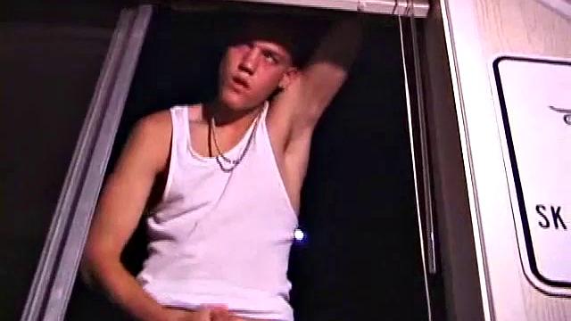 Not content with sitting while he jacks off, Lance teases the neighbors by standing on the roof outside his bedroom window to give everyone a show. Then he finishes by blowing his cum load onto the floor of his bedroom.