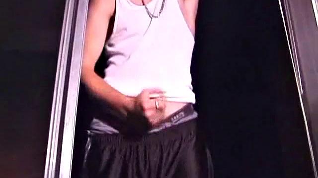 Not content with sitting while he jacks off, Lance teases the neighbors by standing on the roof outside his bedroom window to give everyone a show. Then he finishes by blowing his cum load onto the floor of his bedroom.