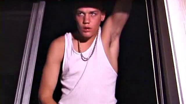 Not content with sitting while he jacks off, Lance teases the neighbors by standing on the roof outside his bedroom window to give everyone a show. Then he finishes by blowing his cum load onto the floor of his bedroom.