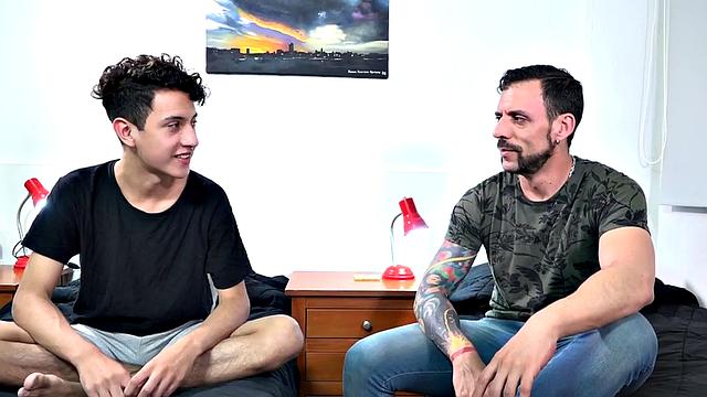 Twink Latino Wilson is on his bed reading when daddy Joris looks for sex. A kiss gets things started and soon the young man is naked and getting his dick sucked.