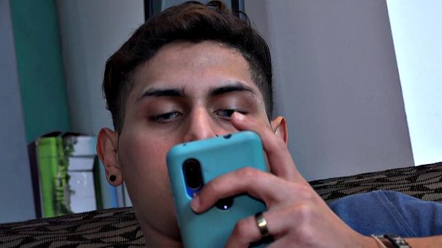 Stretched out on a sofa and watching porn on his phone, Tommy starts working up a stiff one. Once hard, the Latino starts beating off, with eyes glued to the phone.
