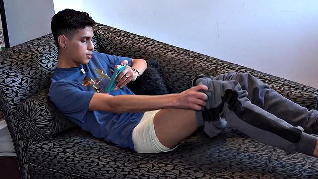 Stretched out on a sofa and watching porn on his phone, Tommy starts working up a stiff one. Once hard, the Latino starts beating off, with eyes glued to the phone.