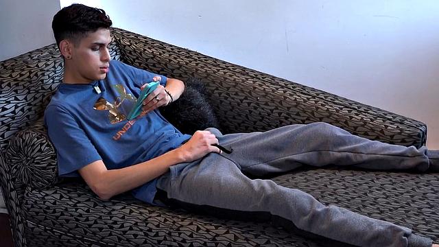 Stretched out on a sofa and watching porn on his phone, Tommy starts working up a stiff one. Once hard, the Latino starts beating off, with eyes glued to the phone.
