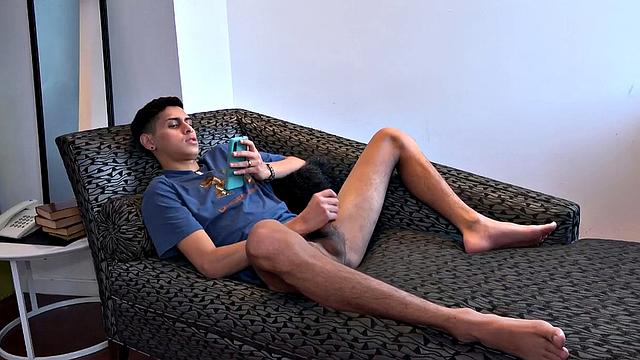 Stretched out on a sofa and watching porn on his phone, Tommy starts working up a stiff one. Once hard, the Latino starts beating off, with eyes glued to the phone.