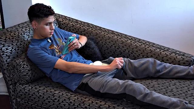 Stretched out on a sofa and watching porn on his phone, Tommy starts working up a stiff one. Once hard, the Latino starts beating off, with eyes glued to the phone.