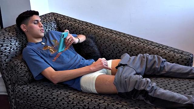 Stretched out on a sofa and watching porn on his phone, Tommy starts working up a stiff one. Once hard, the Latino starts beating off, with eyes glued to the phone.